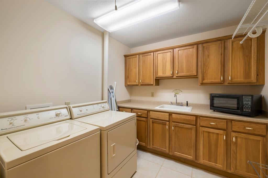 Laundry room with sink and cabinetry